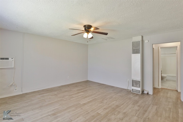 empty room with ceiling fan, a textured ceiling, and light hardwood / wood-style flooring