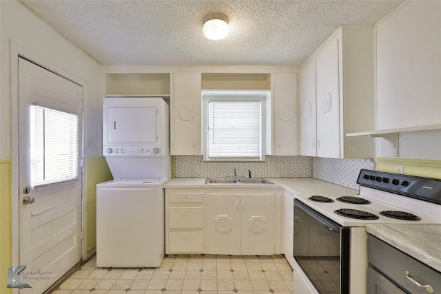 kitchen featuring gray cabinetry, sink, electric range, white cabinetry, and stacked washer / drying machine