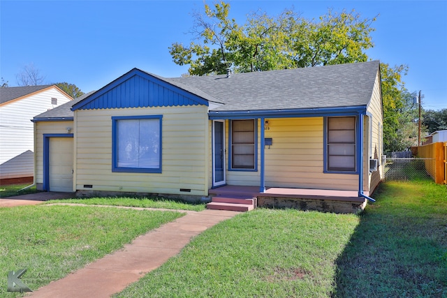 view of front of house with a garage and a front lawn