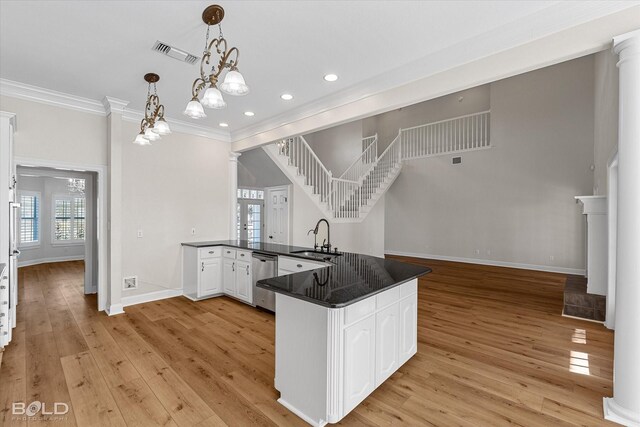 kitchen featuring white cabinetry, kitchen peninsula, sink, and light hardwood / wood-style flooring