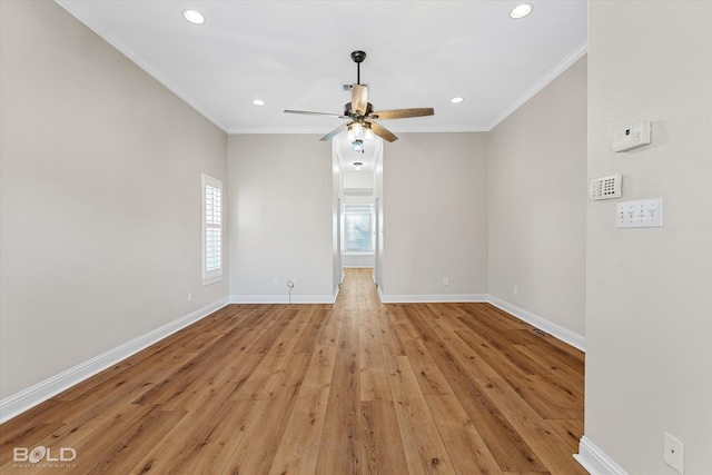 unfurnished room with light hardwood / wood-style flooring, plenty of natural light, ornamental molding, and ceiling fan