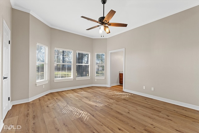 unfurnished room featuring ceiling fan, light wood-type flooring, and crown molding