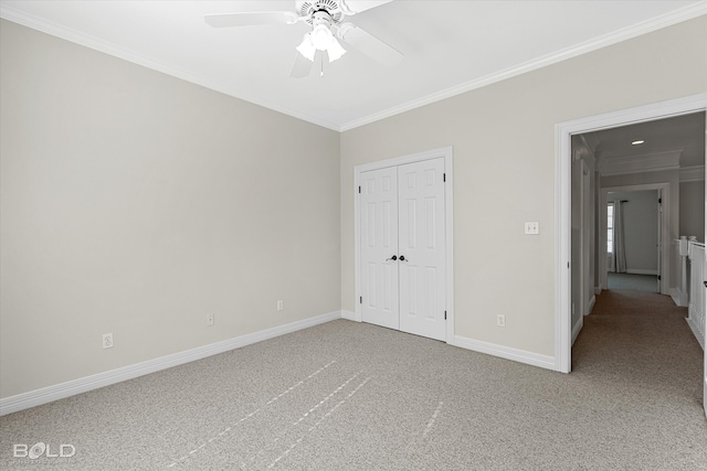 unfurnished bedroom featuring ceiling fan, carpet floors, crown molding, and a closet