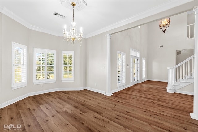 interior space with wood-type flooring, a wealth of natural light, and a notable chandelier