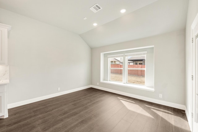 interior space with visible vents, baseboards, lofted ceiling, recessed lighting, and dark wood-style floors