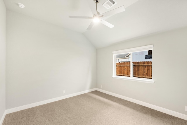 unfurnished room featuring lofted ceiling, carpet flooring, baseboards, and visible vents