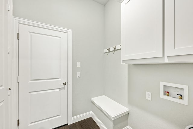 washroom with washer hookup, dark wood-type flooring, cabinet space, and baseboards