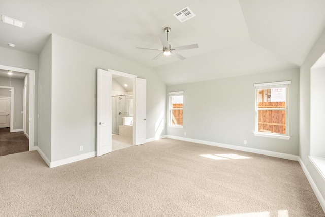 unfurnished bedroom with lofted ceiling, carpet flooring, baseboards, and visible vents