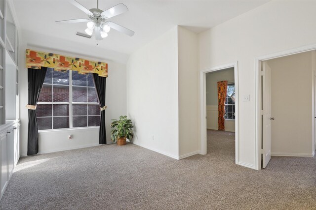 carpeted spare room with ceiling fan