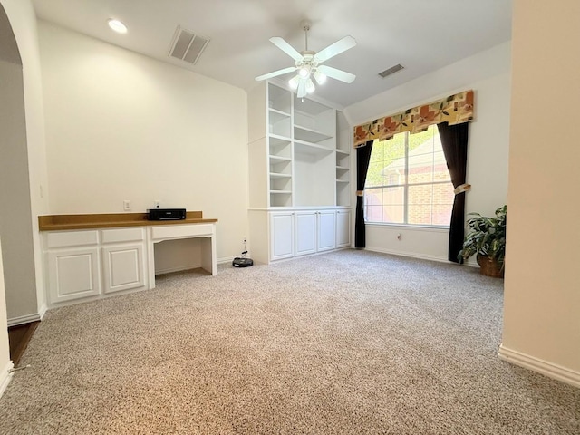 carpeted spare room featuring ceiling fan