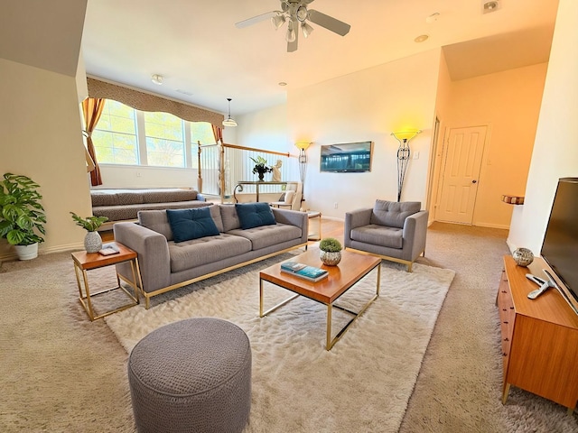 unfurnished living room featuring carpet flooring and ceiling fan