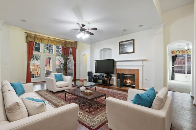 living room featuring a fireplace, ceiling fan, and hardwood / wood-style floors