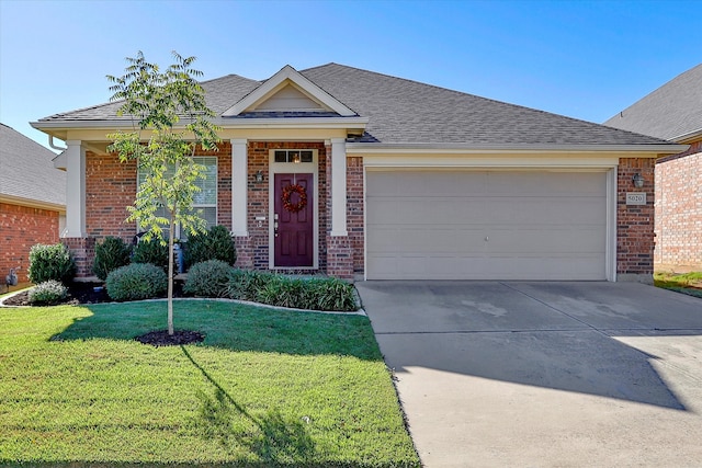 view of front facade featuring a front yard and a garage