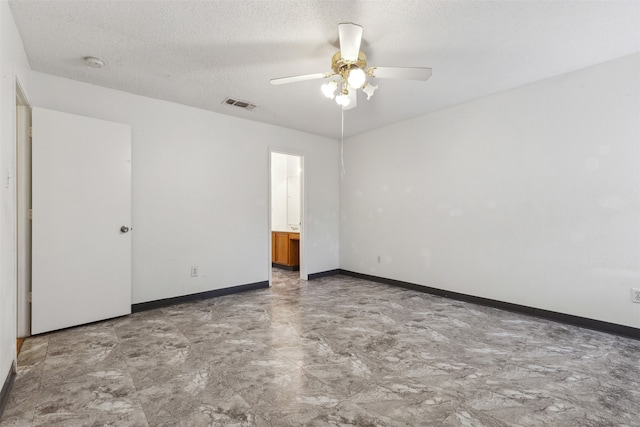 unfurnished room featuring ceiling fan and a textured ceiling