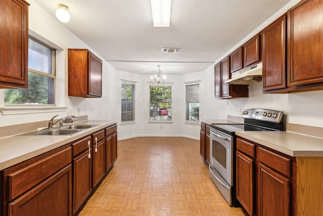 kitchen featuring hanging light fixtures, an inviting chandelier, a textured ceiling, stainless steel range with electric stovetop, and light parquet flooring