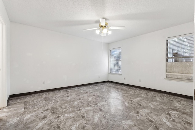 unfurnished room featuring ceiling fan and a textured ceiling