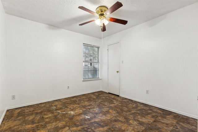 unfurnished room featuring ceiling fan and a textured ceiling