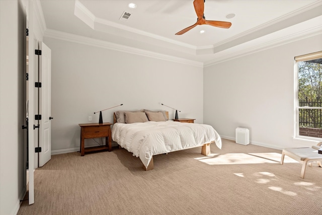 bedroom featuring ceiling fan, light colored carpet, ornamental molding, and a raised ceiling