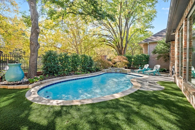 view of pool with a patio and a yard