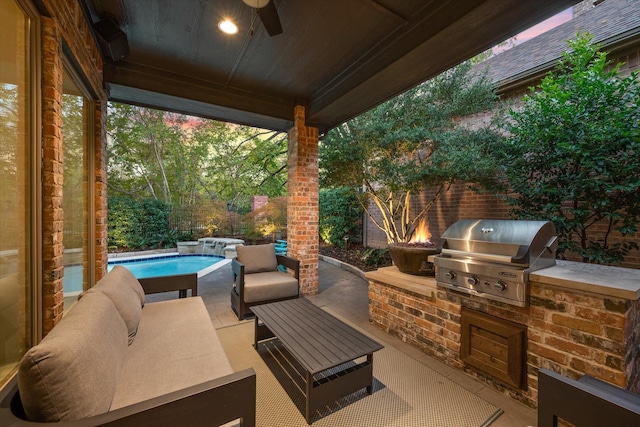 view of patio / terrace featuring exterior kitchen, outdoor lounge area, a fenced in pool, and grilling area