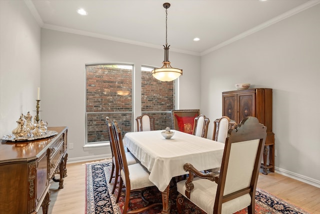 dining area featuring crown molding and light hardwood / wood-style floors