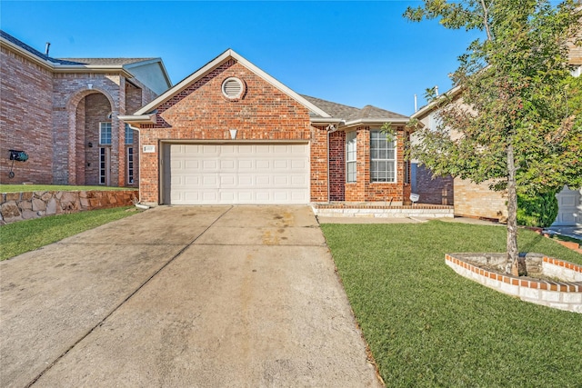 view of front of home featuring a garage and a front lawn