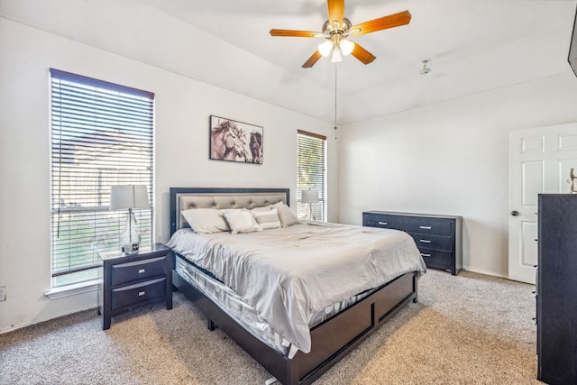 bedroom with ceiling fan, carpet flooring, multiple windows, and lofted ceiling