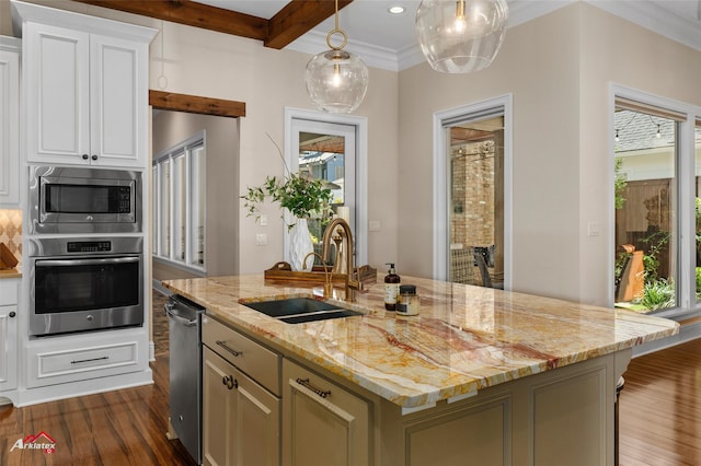 kitchen with stainless steel appliances, a kitchen island with sink, sink, dark hardwood / wood-style floors, and white cabinetry