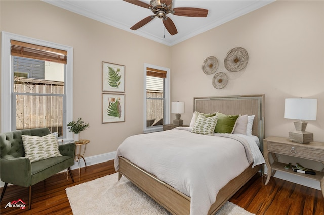 bedroom featuring ceiling fan, ornamental molding, and dark wood-type flooring