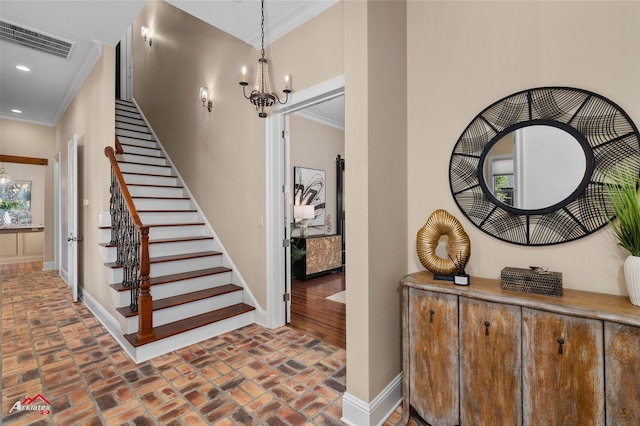 staircase featuring a wealth of natural light, crown molding, and a notable chandelier