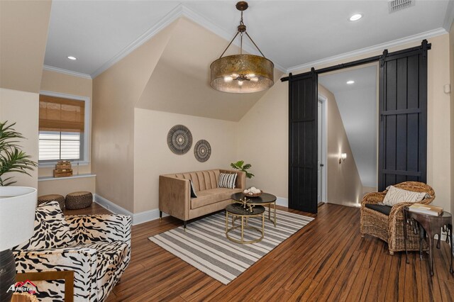 living room featuring a barn door, dark hardwood / wood-style flooring, and ornamental molding