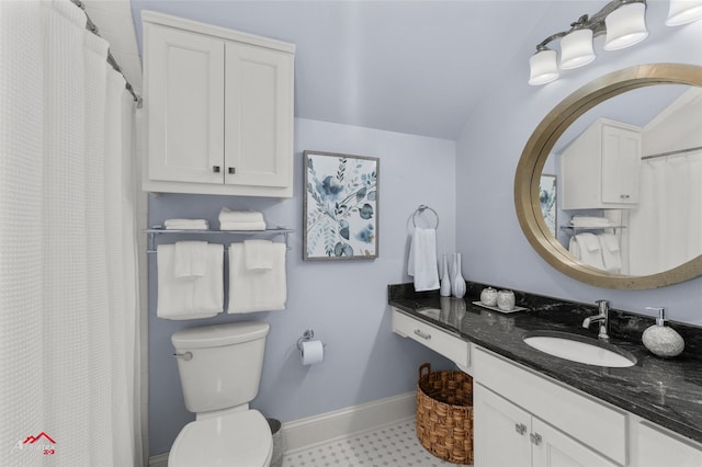 bathroom featuring vanity, toilet, and lofted ceiling