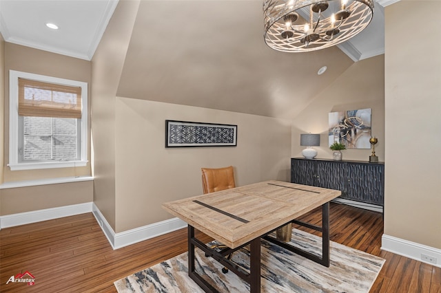 dining area featuring hardwood / wood-style floors, a chandelier, vaulted ceiling, and ornamental molding