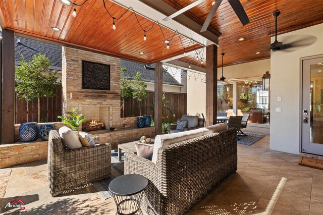 view of patio / terrace featuring an outdoor living space with a fireplace and ceiling fan