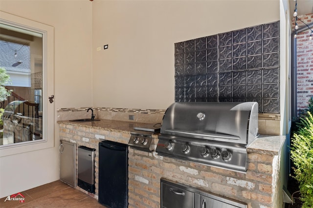 view of patio / terrace featuring an outdoor kitchen, sink, and grilling area