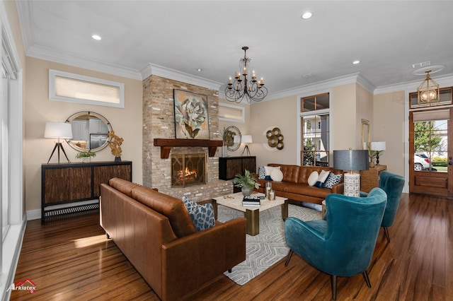 living room with a fireplace, wood-type flooring, a chandelier, and crown molding