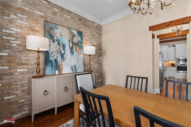 dining space with an inviting chandelier, dark wood-type flooring, brick wall, and ornamental molding