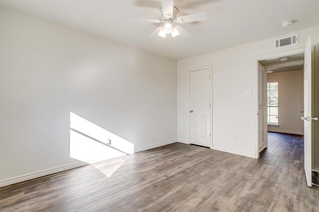 spare room with ceiling fan and light hardwood / wood-style flooring