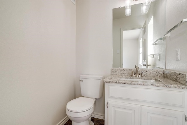 728 E 3rd St, Springtown, TX 76082 - bathroom with toilet, vanity, and baseboards