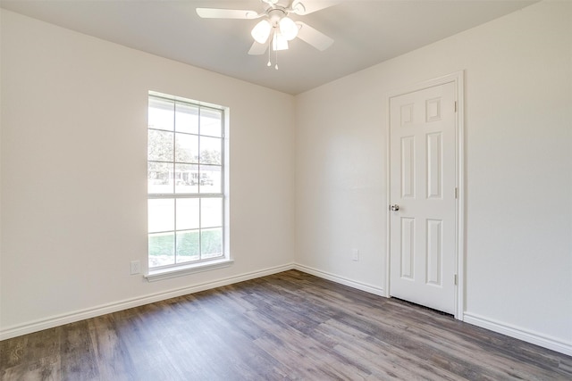 empty room with hardwood / wood-style flooring, ceiling fan, and a healthy amount of sunlight