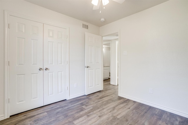 unfurnished bedroom with a closet, ceiling fan, and light hardwood / wood-style flooring