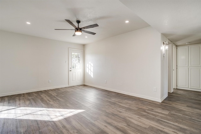 empty room with hardwood / wood-style floors and ceiling fan