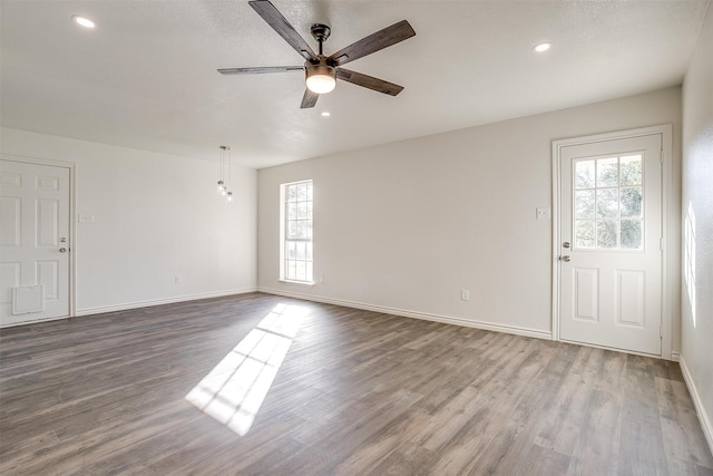 interior space with ceiling fan and hardwood / wood-style floors