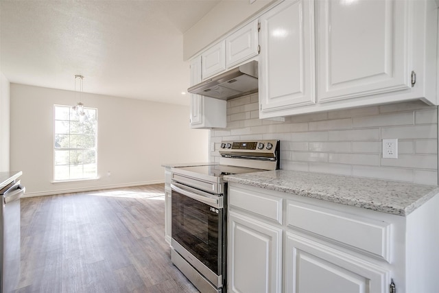 kitchen featuring pendant lighting, light hardwood / wood-style flooring, appliances with stainless steel finishes, tasteful backsplash, and white cabinetry