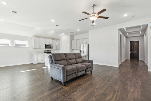 living room featuring ceiling fan and dark wood-type flooring