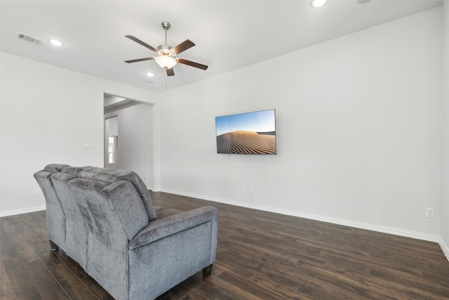 sitting room with ceiling fan and dark wood-type flooring