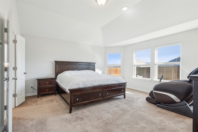 bedroom with light carpet and high vaulted ceiling