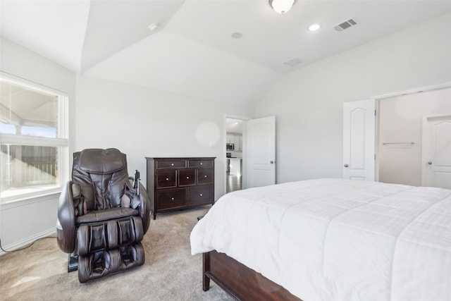 bedroom with light carpet and vaulted ceiling