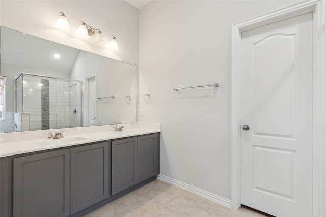 bathroom with tile patterned floors, vanity, lofted ceiling, and walk in shower