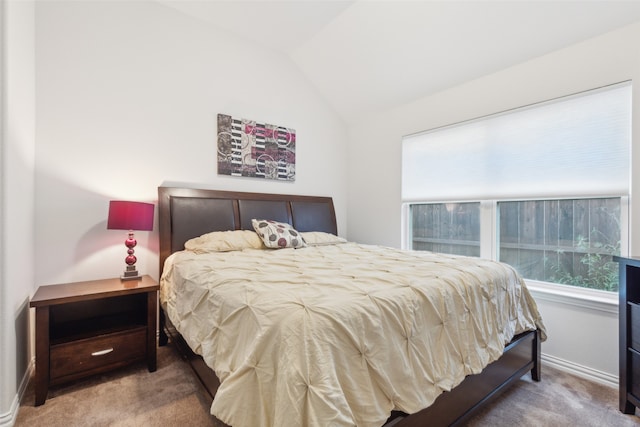 bedroom featuring carpet flooring, vaulted ceiling, and multiple windows